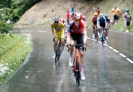 Tadej Pogacar, in yellow, chases down Thymen Arensman on stage 19