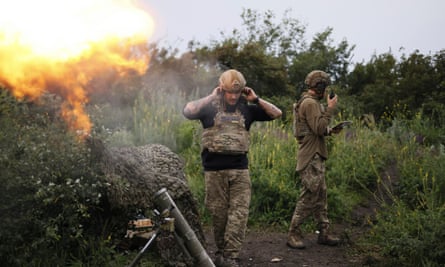 Ukrainian soldiers fire at Russian positions near Bakhmut.