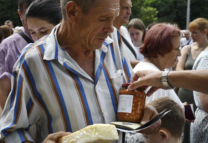 A man receives food at a humanitarian aid distribution point in Zaporizhzhia, Ukraine.