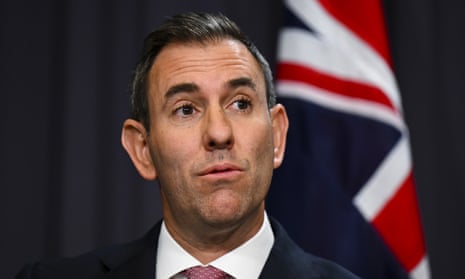 headshot of jim chalmers in front of an australian flag