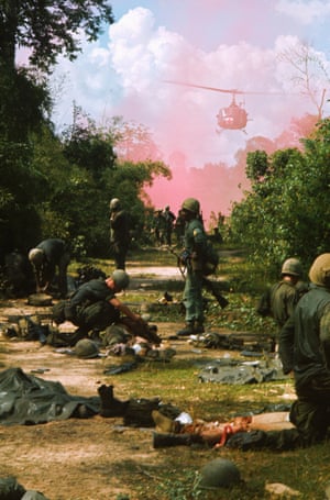 A US medical helicopter emerges through a pink cloud to evacuate wounded survivors of the 173rd Airborne regiment, ambushed in War Zone C – the Viet Cong base zone, known as the Iron Triangle, in 1965