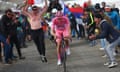 CYCLING-ITA-GIRO<br>Pink jersey Team UAE's Slovenian rider Tadej Pogacar climbs surrounded by fans to win the 15th stage of the 107th Giro d'Italia cycling race, 222km between Manerba del Garda and Mottolino on May 19, 2024. (Photo by Luca Bettini / POOL / AFP) (Photo by LUCA BETTINI/POOL/AFP via Getty Images)