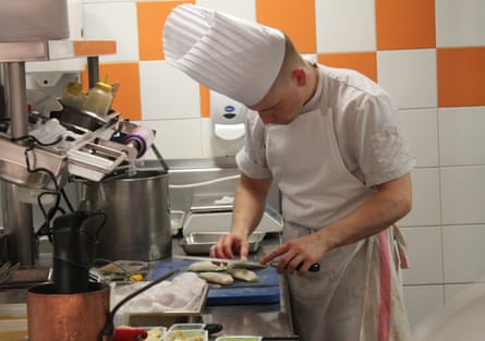 A chef cuts some food.