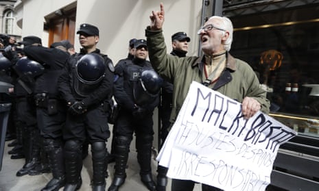 A man protests against a police search at the home of Senator and former president Cristina Fernandez. The search was part of a larger corruption investigation.