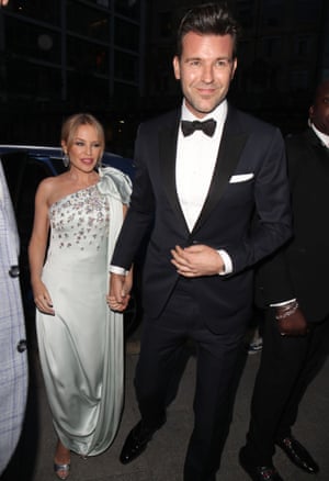 Kylie Minogue dressed in a silver gown, with her boyfriend, GQ creative director Paul Solomons, in black tie, in September 2019.
