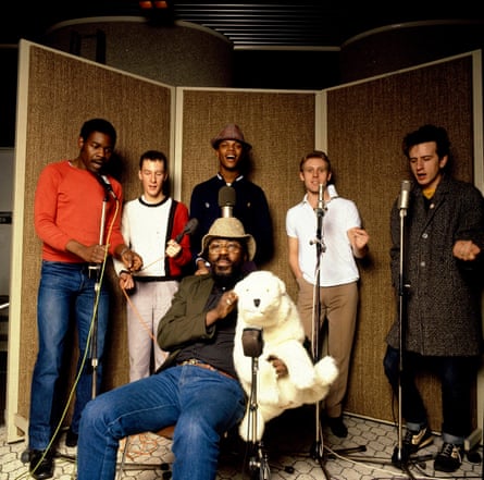 The Beat including Everett Morton (left), Saxa (with fluffy toy) and Ranking Roger (wearing hat).