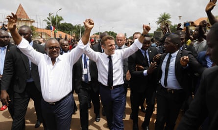 French president Emmanuel Macron and Guinea-Bissau’s president, Umaro Sissoco Embalo, gesture to the crowd in front of the presidential palace in Bissau in July 2022