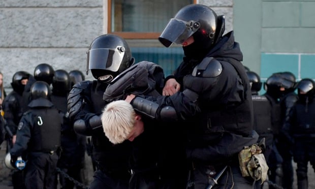 Police officers detain a man in Saint Petersburg on 24 September
