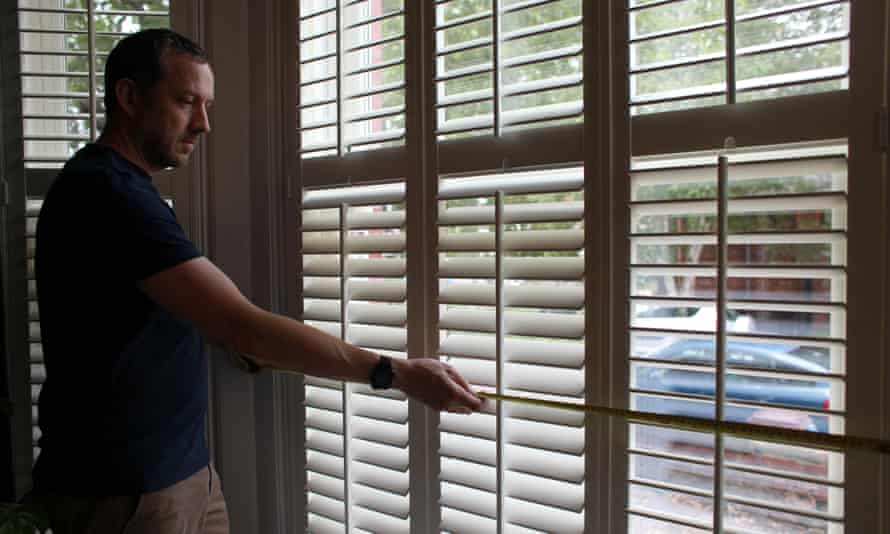 Richard Shears, measuring a window as he assesses a house for retrofitting