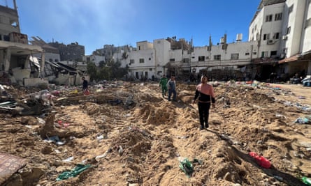 People inspect damages after an Israeli raid at Kamal Adwan hospital in the northern Gaza Strip.