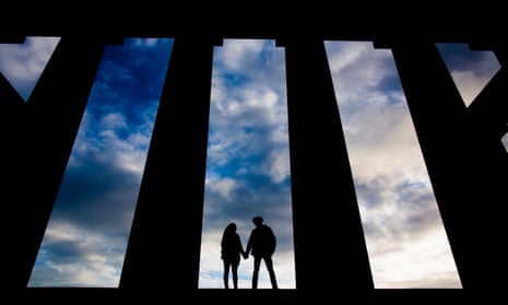 Silhouetted couple holding hands