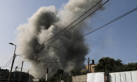 Smoke billows above buildings following an Israeli airstrike at the al-Nuseirat refugee camp in central Gaza on Friday.