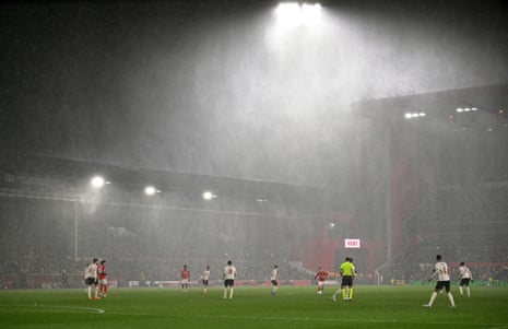 A general view of play as torrential rain pours down into the stadium