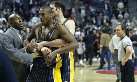 So astonishing it could never be scripted ... Indiana Pacers’ Ron Artest is restrained by Austin Croshere after the team’s game with Detroit Pistons in 2004.