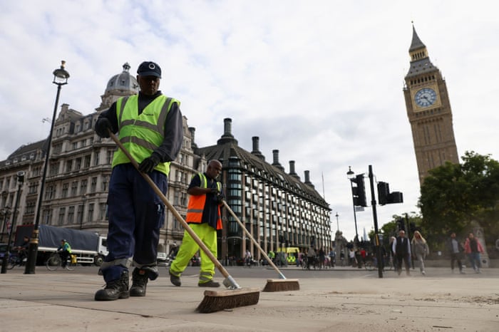 Cleaners sweeping the streets in Parliament Square this morning following the funeral of Queen Elizabeth yesterday.