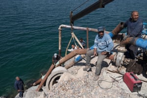 Workers on the Tabqa dam (also known as Lake Assad) replace pipes.