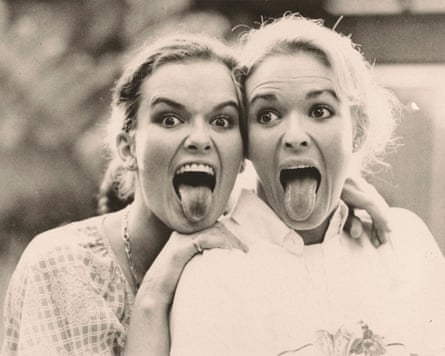 Two blond women sticking their tongues out for a laugh