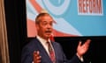 Nigel Farage standing in front of a slide that says 'Reform'