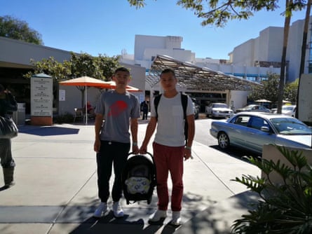 Li, left, and Xu outside the hospital with their newborn.