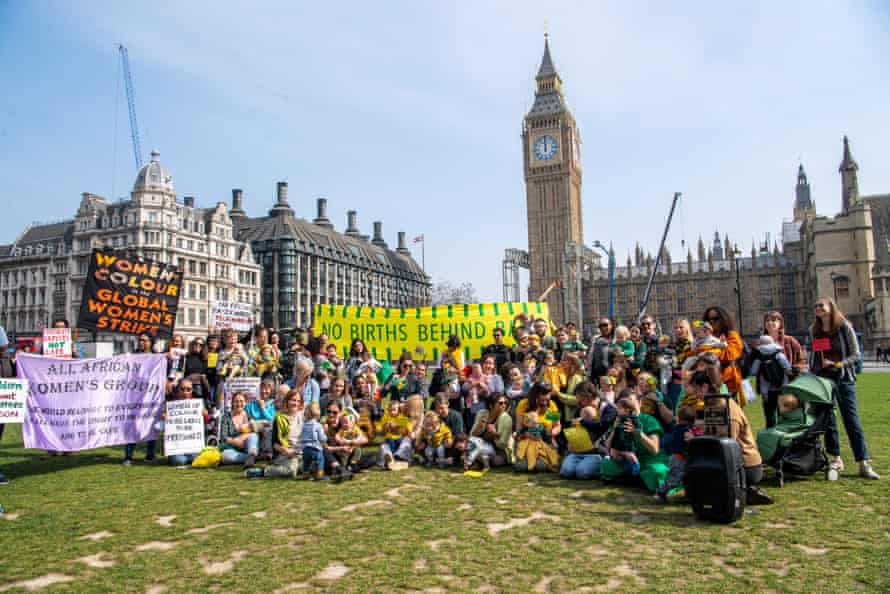 Mothers and babies pose for a group photo as part of the protest.