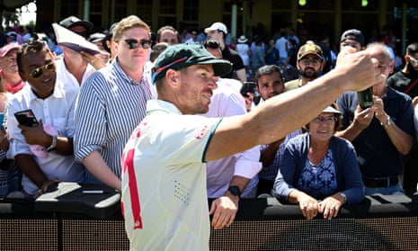 David Warner takes photographs with spectators following Australia’s win in the third Test at the SCG
