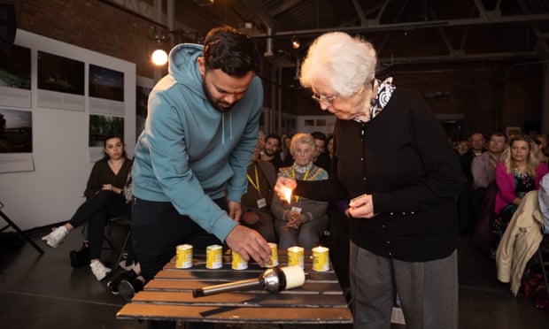 Azeem Rafiq helps to light a candle during his visit to Auschwitz-Birkenau