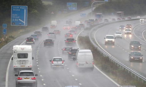 Cars driving in rain on motorway.