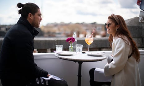 A couple sit in a restaurant on the roof of the Selfridges department store on Oxford Street, London.