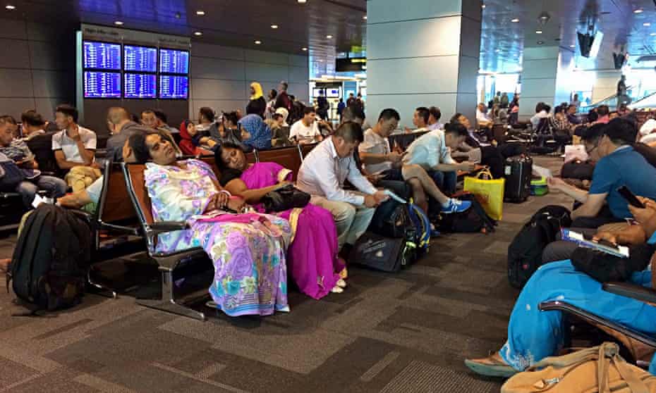 Passengers of cancelled flights wait in Hamad international airport in Doha, Qatar.