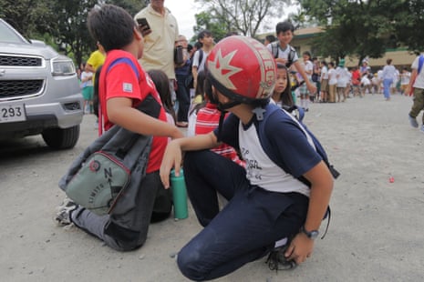 Children evacuate a school in Davao City