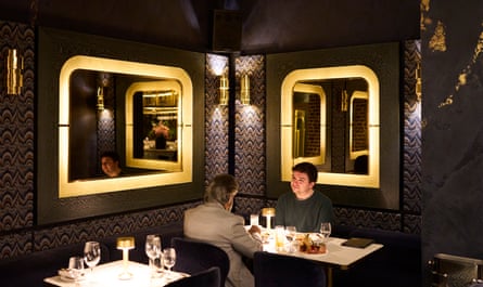 Two men facing each other across a restaurant table