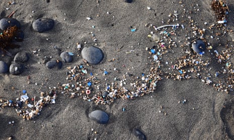 Small plastic parts and microplastics in sand.