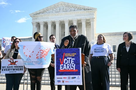 Rev William Barber II speaks at a microphone beside a 'Vote Early' sign outside the US supreme court.
