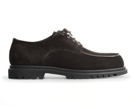 A Cos chunky suede derby shoe in black. The shoe is side on and has laces.