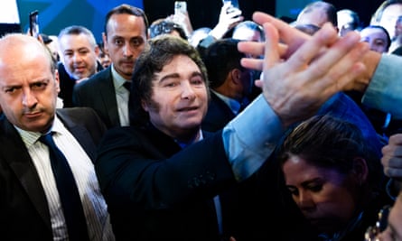a man in a suit shakes hands within a crowd