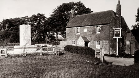Vintage postcard featuring the Bat and Ball Inn and the Hambledon Stone at Broadhalfpenny Down in Hambledon, Hampshire, circa 1910. The memorial stone marks the original site of Hambledon Cricket Club.