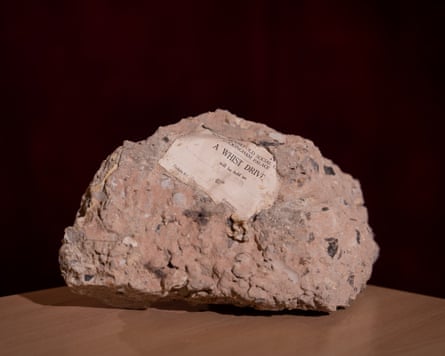 Small ticket embedded in lump of rock