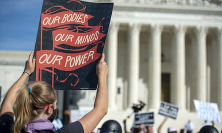 Women’s March protesters hold signs showing support for abortion and reproductive rights outside the Supreme Court in Washington DC on Saturday.