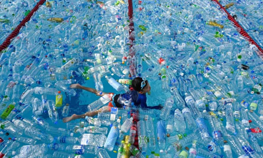 A child swims in a pool filled with plastic bottles during a World Oceans Day awareness campaign in Bangkok.