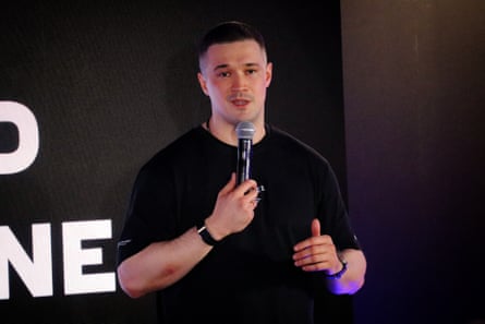 Mykhailo Fedorov, wearing a black T-shirt, talks into a microphone