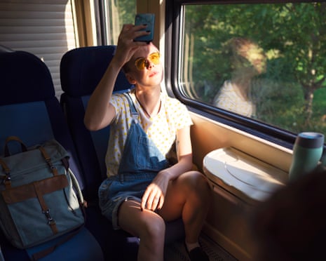 Girl traveling on a train using a cell phone