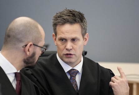 The lead prosecutor, Sturla Henriksbø (right), in discussions with another man in court
