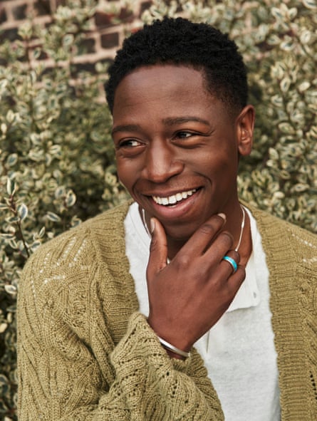 David Jonsson smiling, looking to one side and wearing a green cardigan and a white top.
