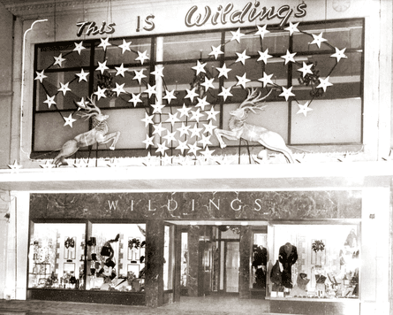A black and white shot of Christmas decorations in a store window