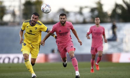 Real Madrid’s Nacho (right) vies for the ball with Álvaro Negredo.