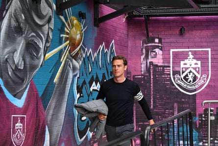 Burnley manager Scott Parker walks in front of a mural at Turf Moor