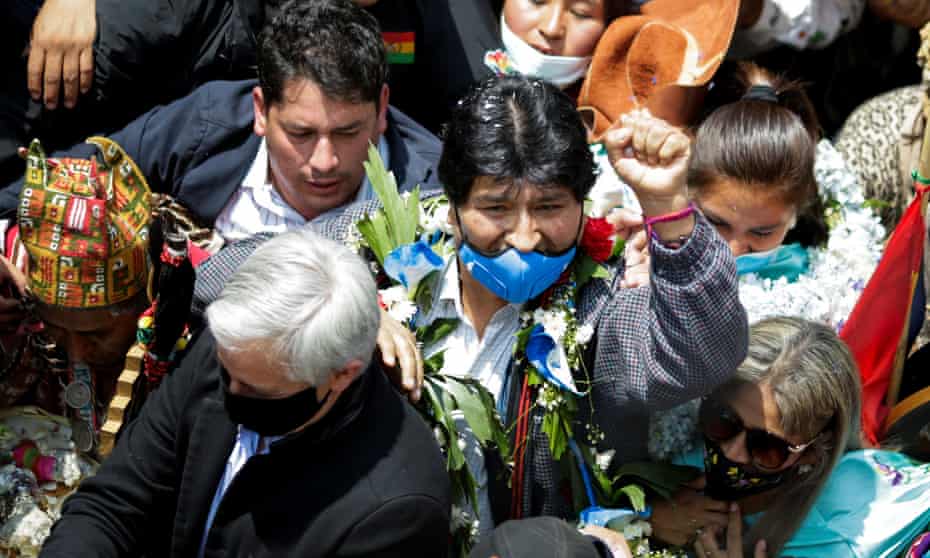 Evo Morales raises a fist as he returns at the border town of Villazón, Bolivia, on 9 November. 