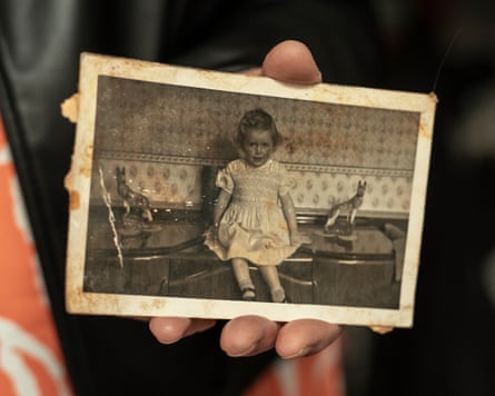 Close up of hand holding old photograph of Gaynor