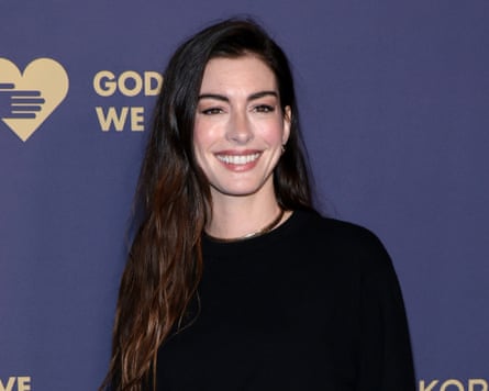 woman in black dress smiles