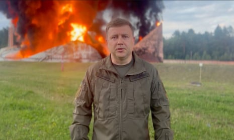 Rivne governor Vitaly Koval stands in front of a burning fuel depot following an attack by Russia.